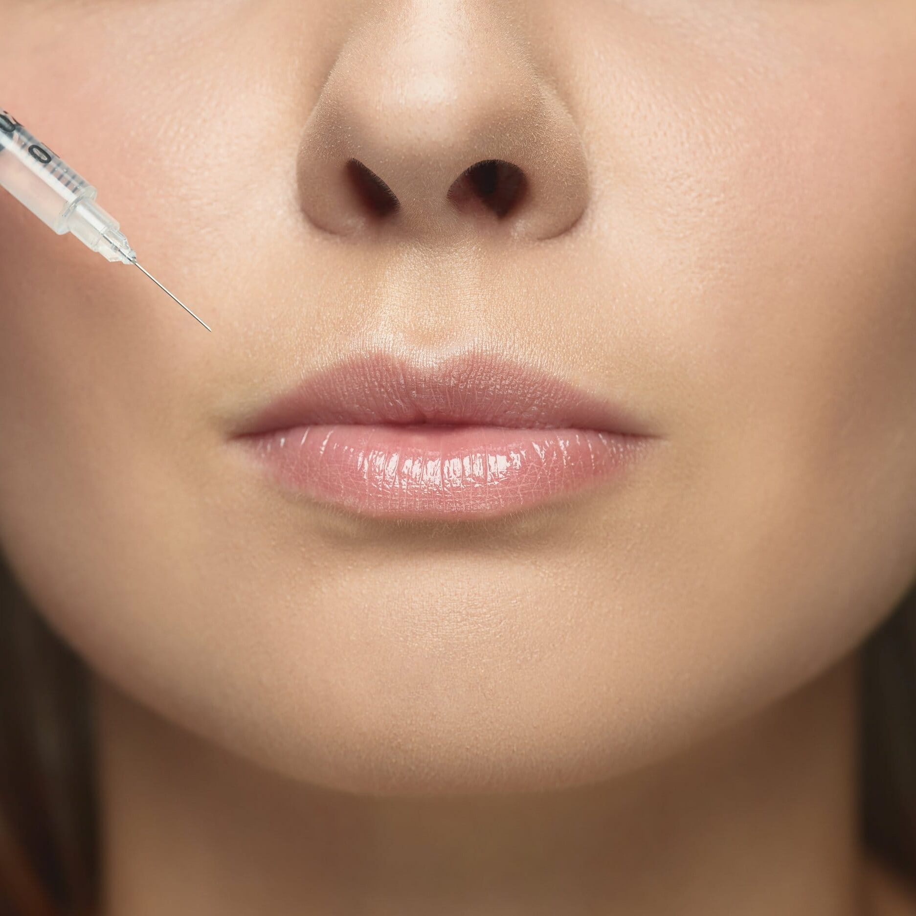 Portrait of beautiful young woman isolated on white studio background lip fillers windsor